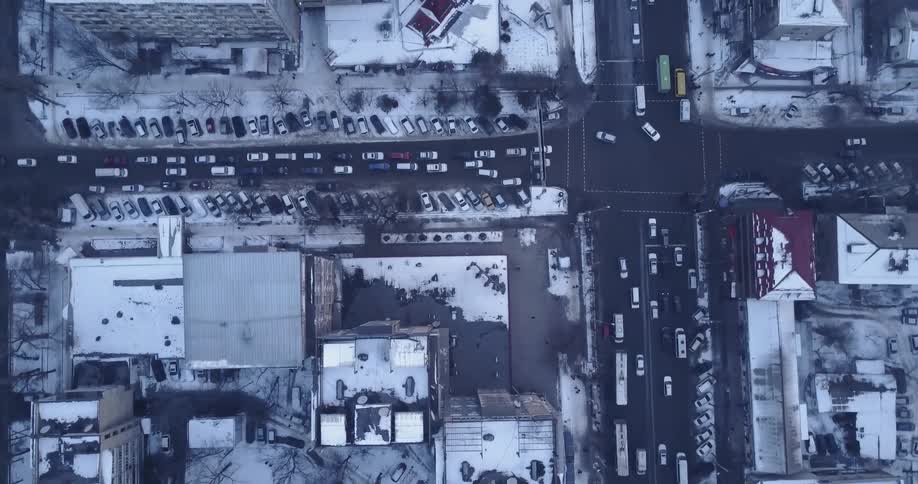 Traffic flows through a city intersection on a winter day
