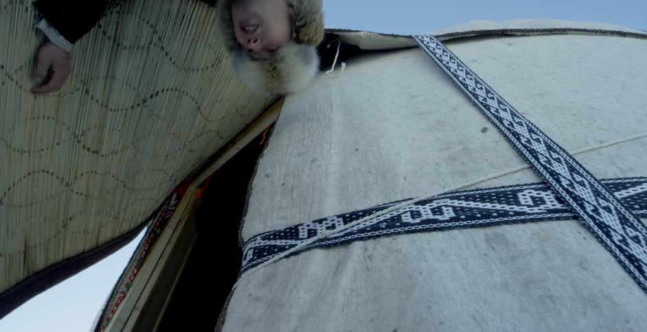 A man enters a yurt