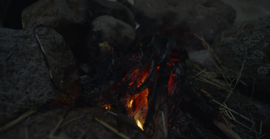 Smoke rises from a campfire