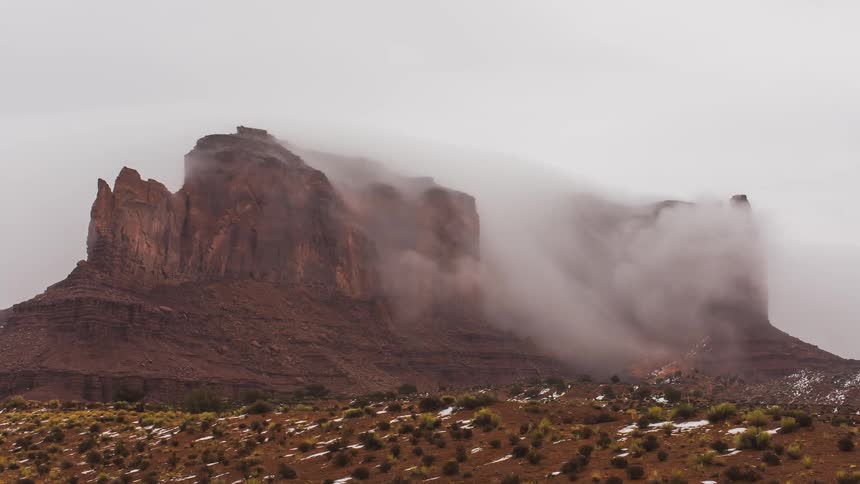 Time lapse of clouds pouring off a mountain top