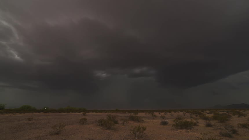 Storm clouds float over a desert