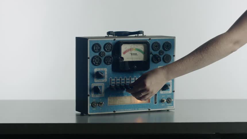 A person turns knobs on the device