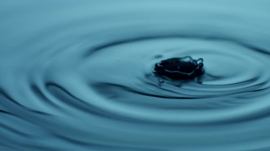 The water drops causing waves to spread out