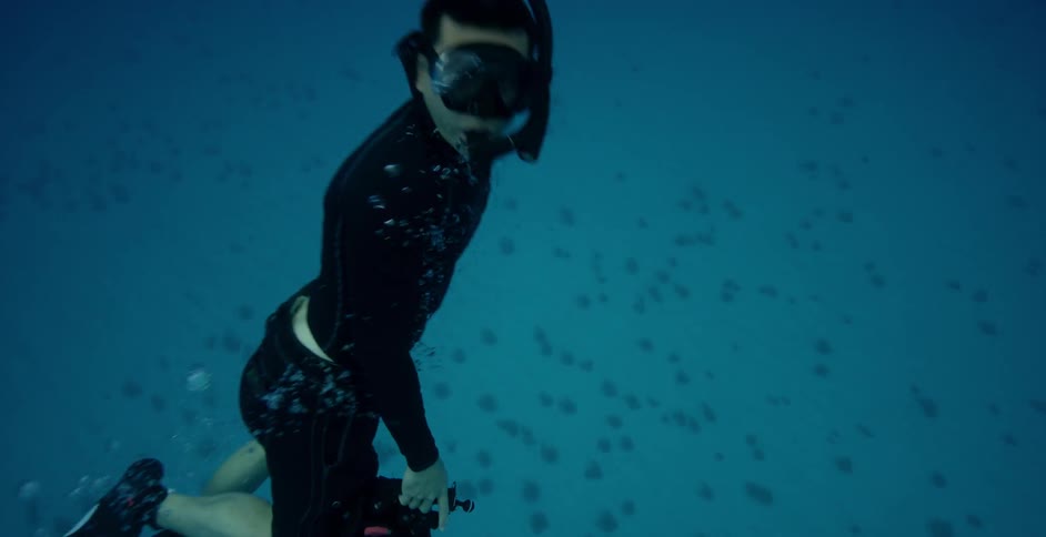 Snorkeler swims to the water's surface