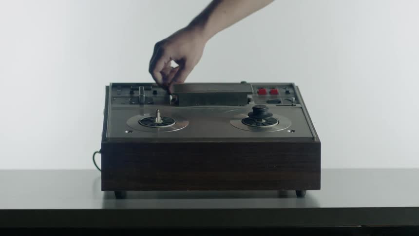 A person turns dials on a piece of equipment