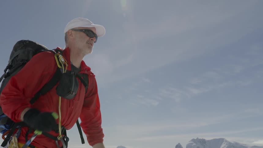 Person uses ski poles to hike over snow