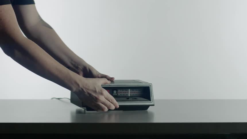 Person sets an old clock on a table