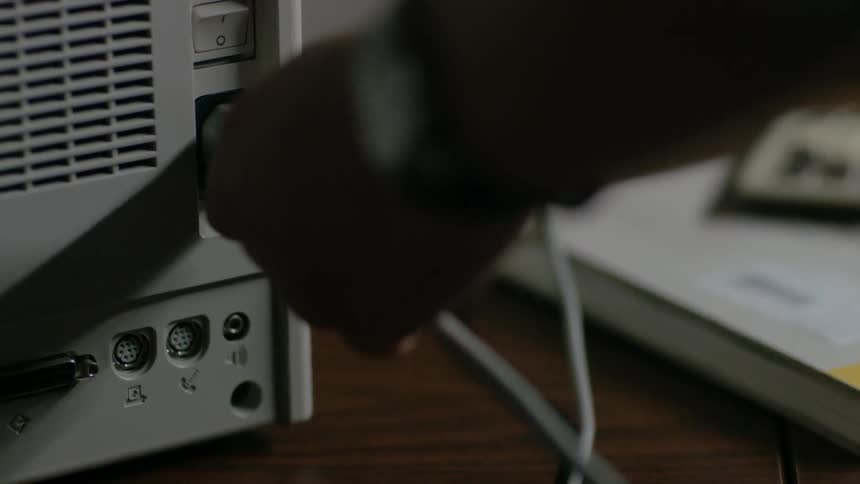 A person plugs the wire into the machine