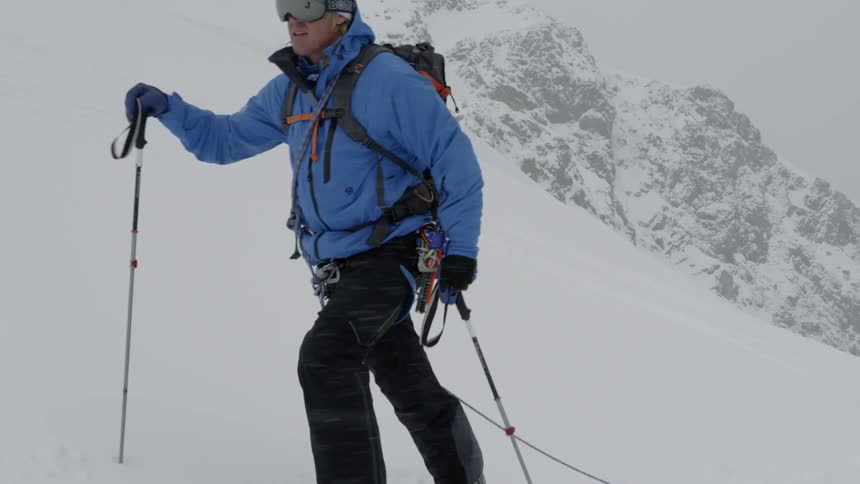 Skiers climbing a snowy hill