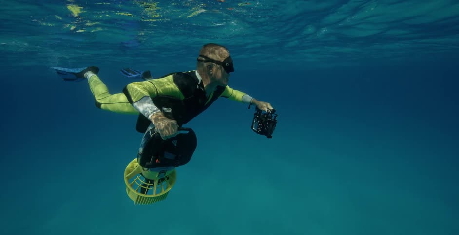 Underwater diver swims near the surface