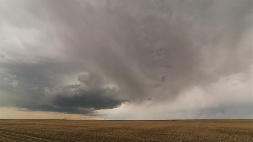 Ominous clouds float over a field