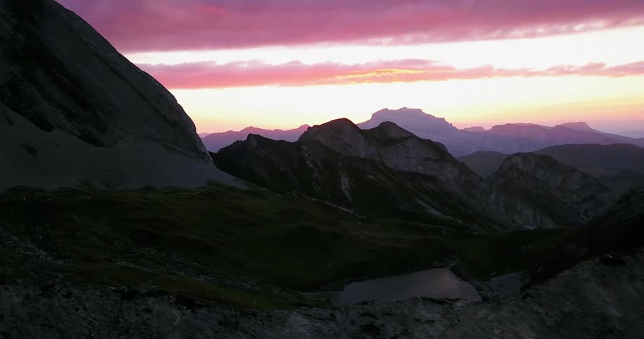 The sun is setting behind the mountain range