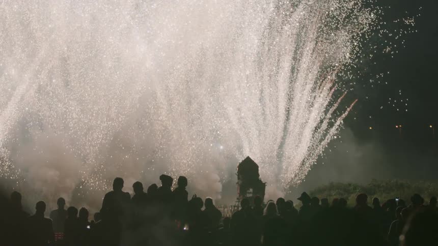 Fireworks explode in the night sky