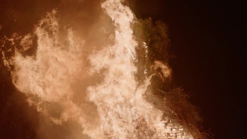 Smoke rises from the land below