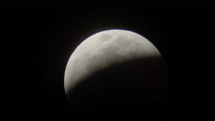 The moon is high in the sky with a quarter showing