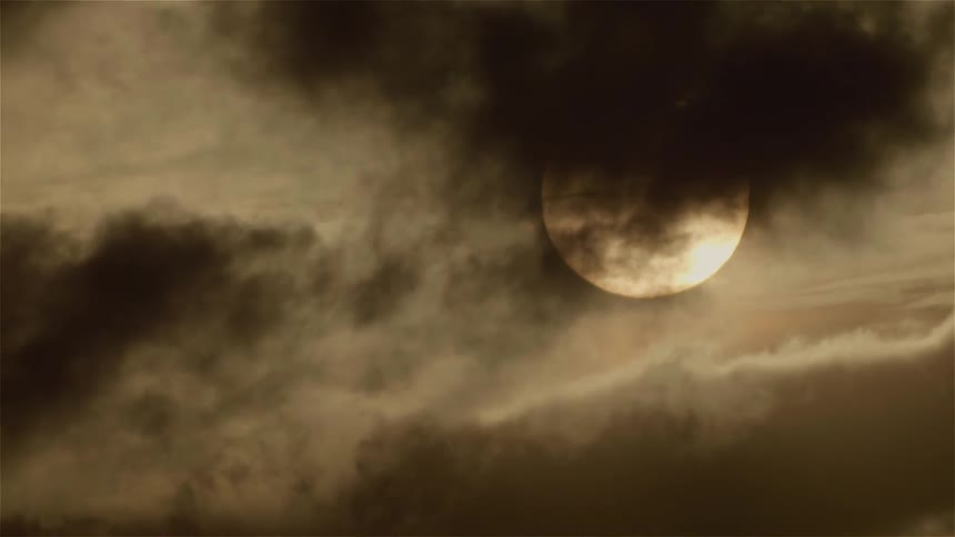 Clouds float in front of the moon