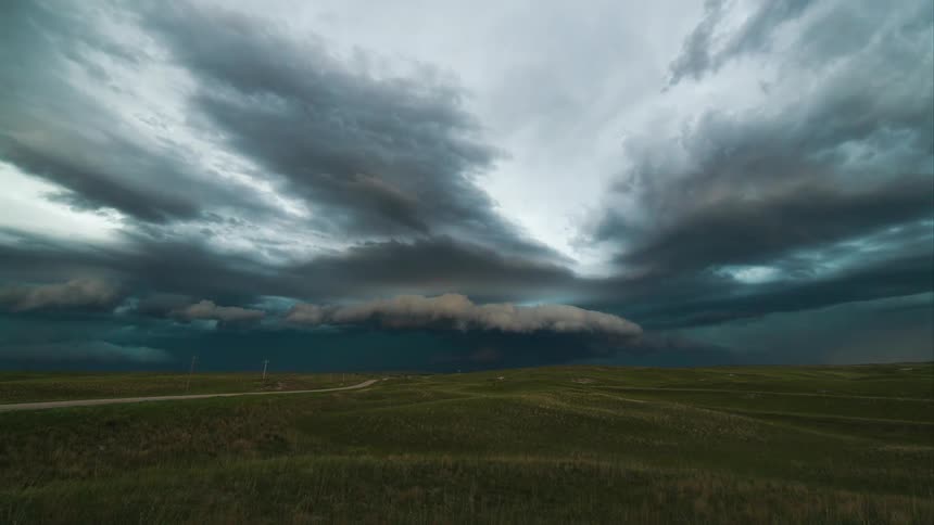 Storm clouds float over a field