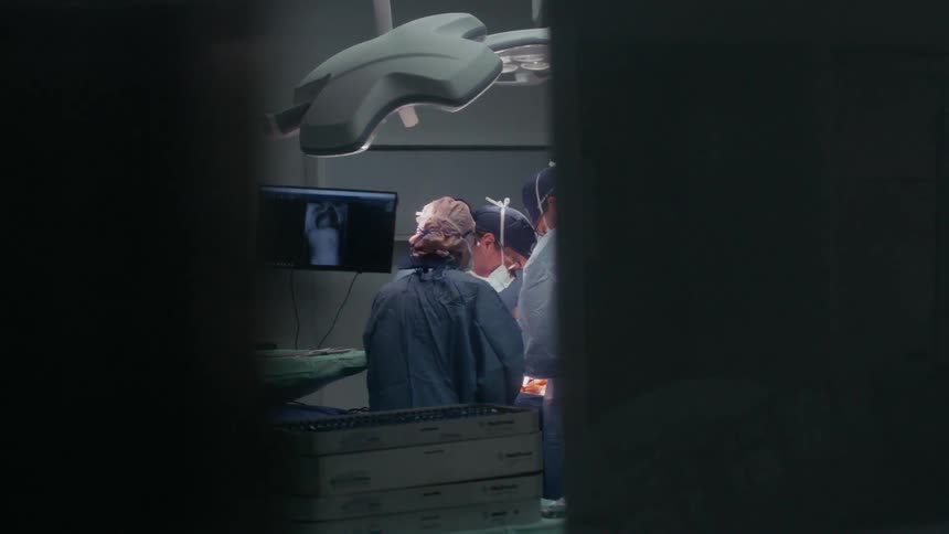 Doctors and nurses performing surgery