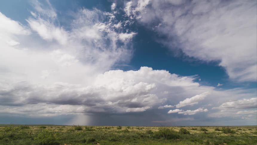 Clouds float over an empty field