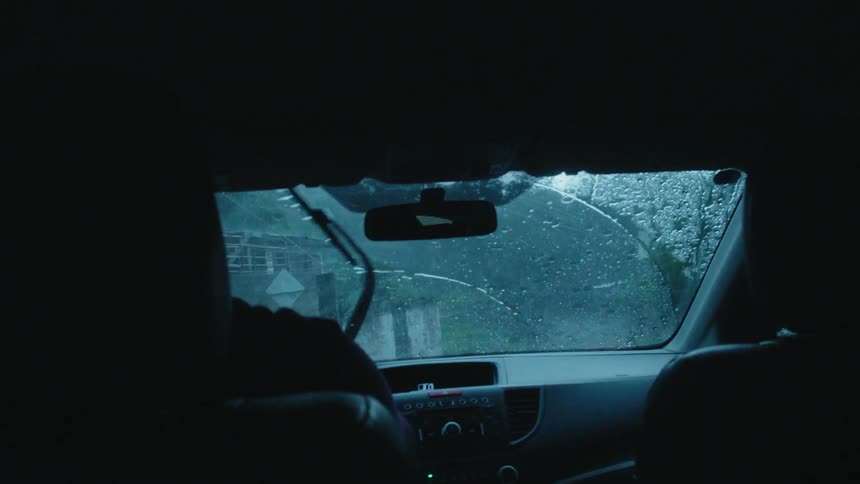 Windshield wipers move back and forth on the windshield