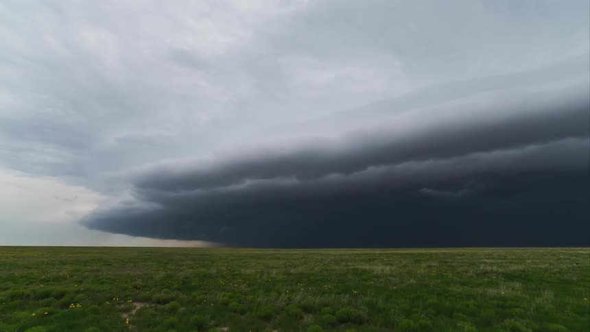 Ominous clouds passing over a grass field
