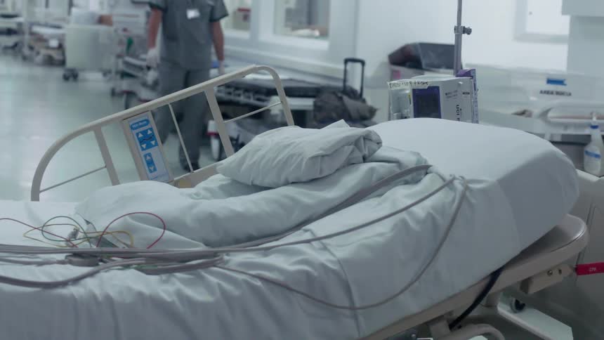 Hospital bed sits empty in the hallway