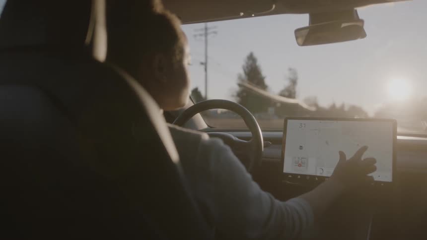 A woman uses navigation while driving a car