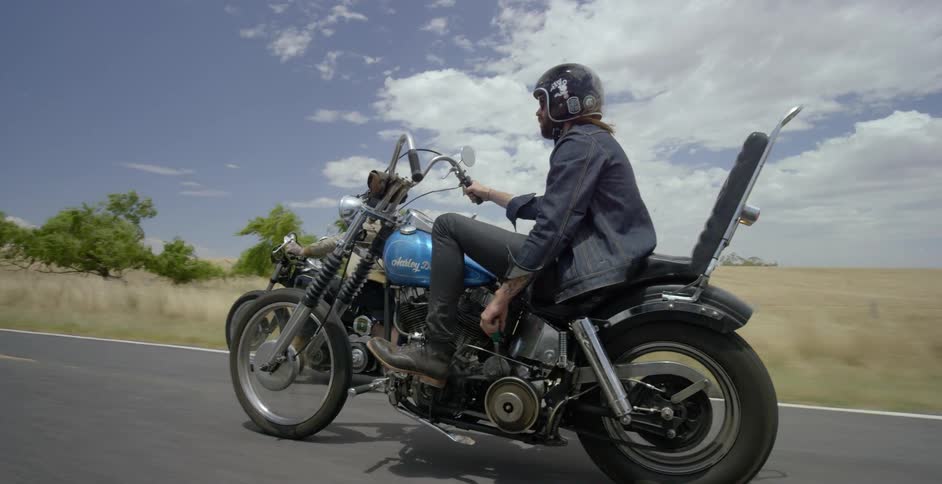 Motorcyclists ride on a rural road