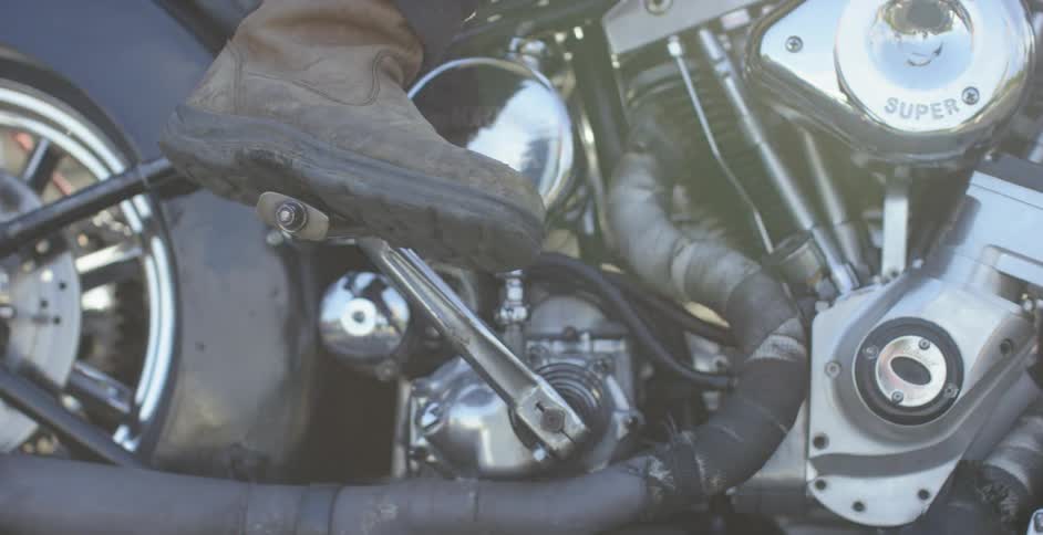 A motorcyclist starts a motorcycle