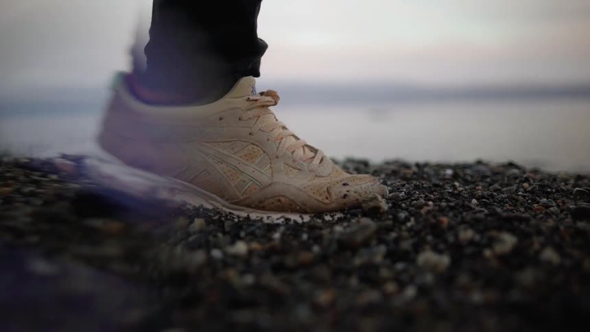 A person walks over dirt and rocks