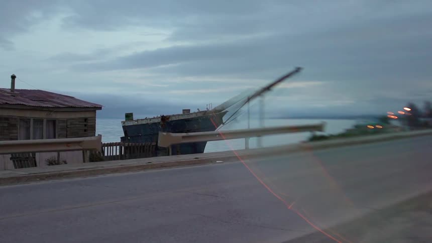 Ship parked in the harbor next to a building