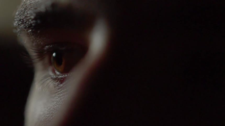 A man's eye looks around