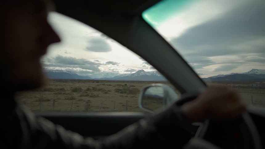 A man drives through a rural area