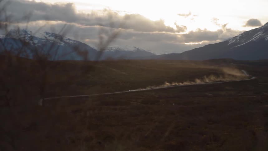 The sun is setting behind the bright landscape ahead