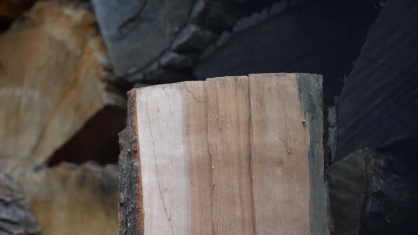 A hatchet slams down splitting the log