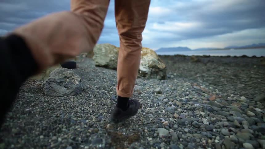 A person runs and jumps over rocks