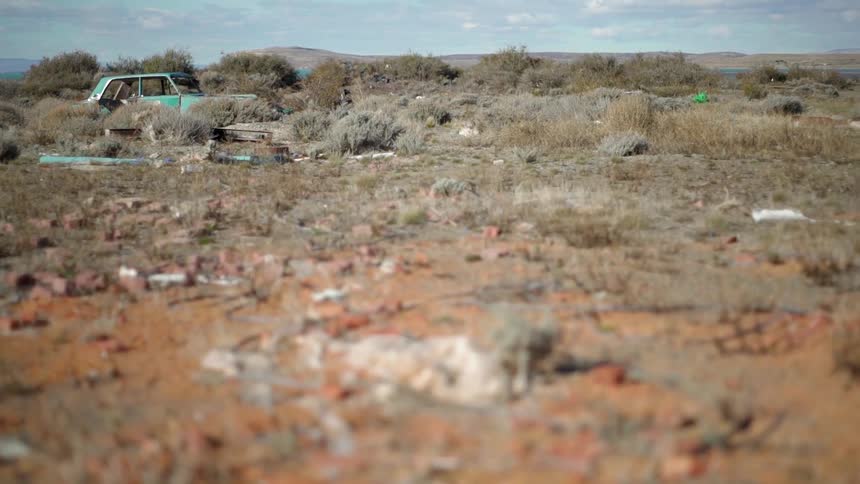 The wreck of a car in the desert