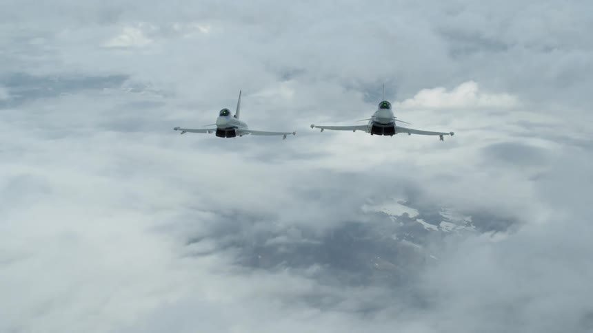 Two jets soar above the clouds