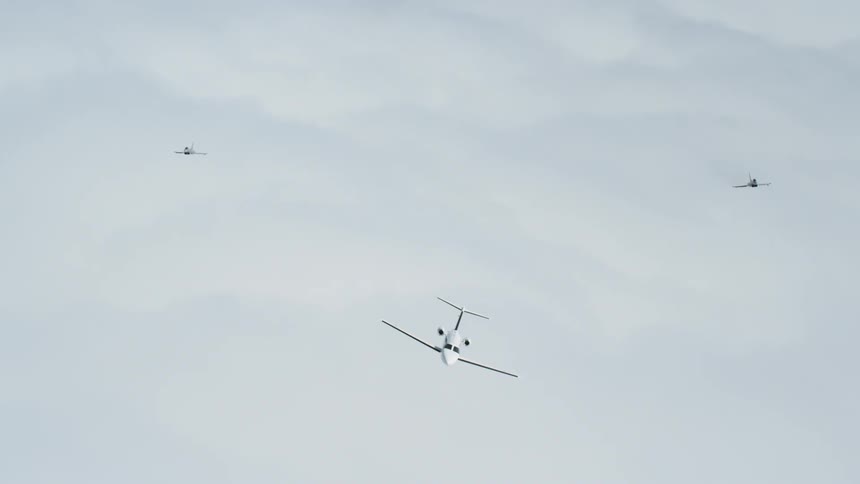 Jets fly above clouds in the sky