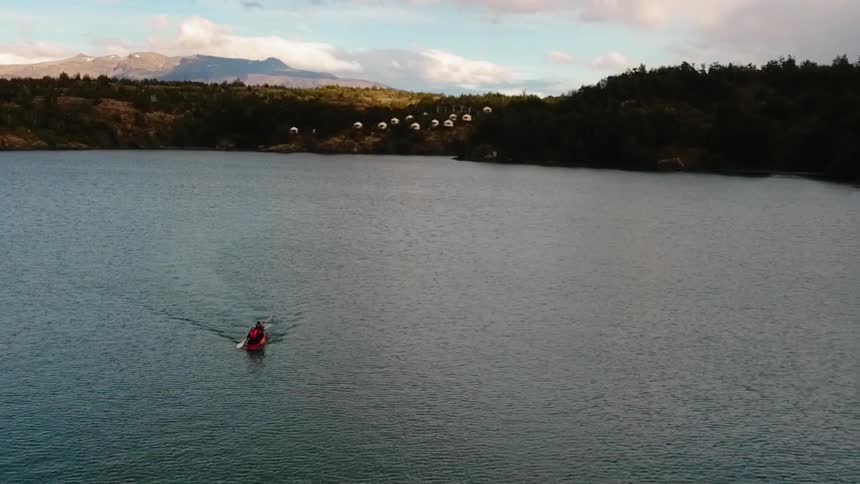 A person kayaks on a lake
