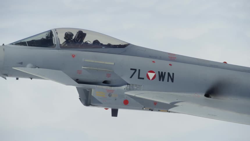 Fighter jet flies above the clouds