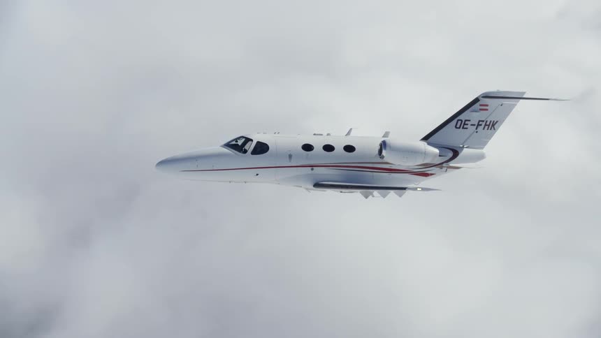A plane flies above clouds