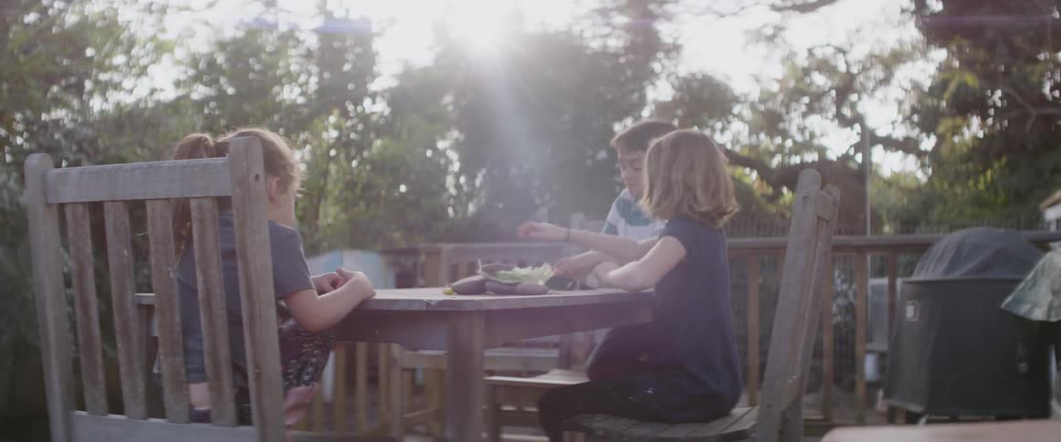 Child sit at a patio table