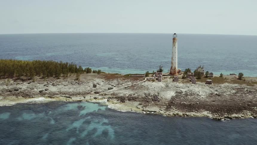 Rustic lighthouse standing on a thin island