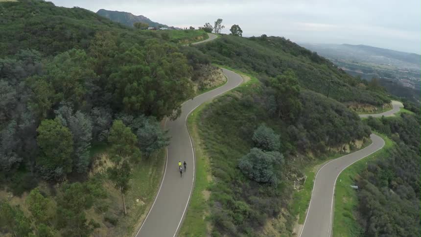 Bikers are biking down the hill