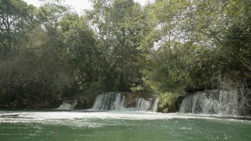 Small waterfalls running into its basin in a forest
