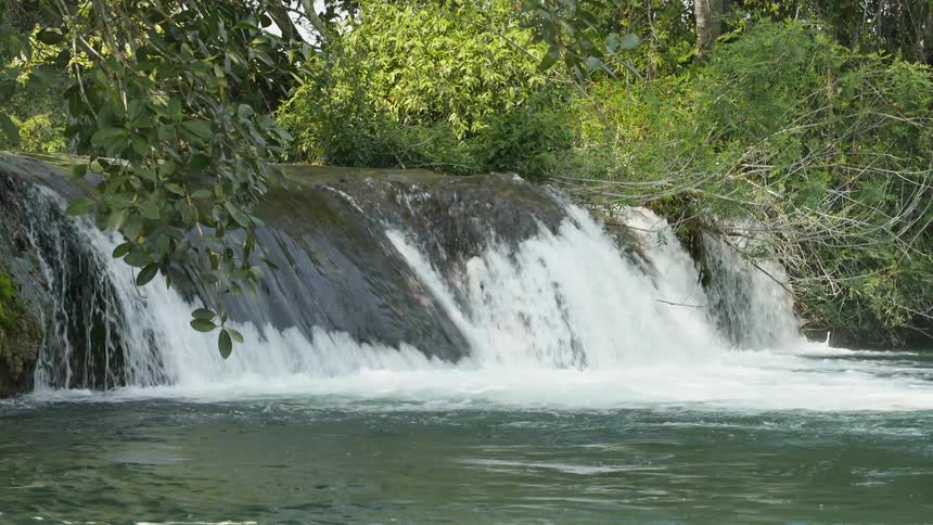 Water flows and splashes over a waterfall
