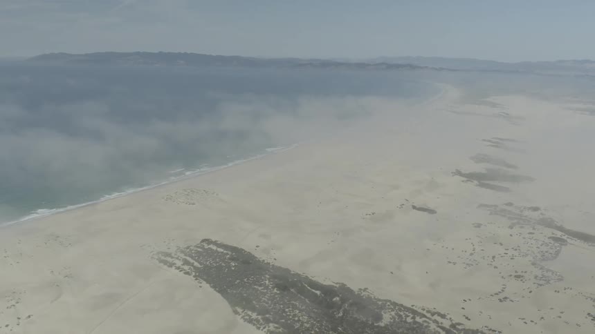 Haze hangs over a beach area