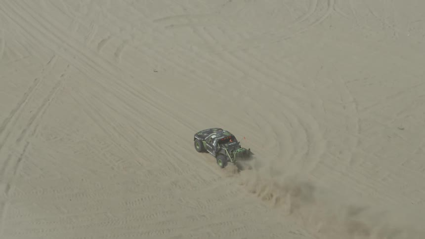 A car is driving across the desert