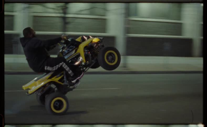A person is drives their four wheeler past incoming cars